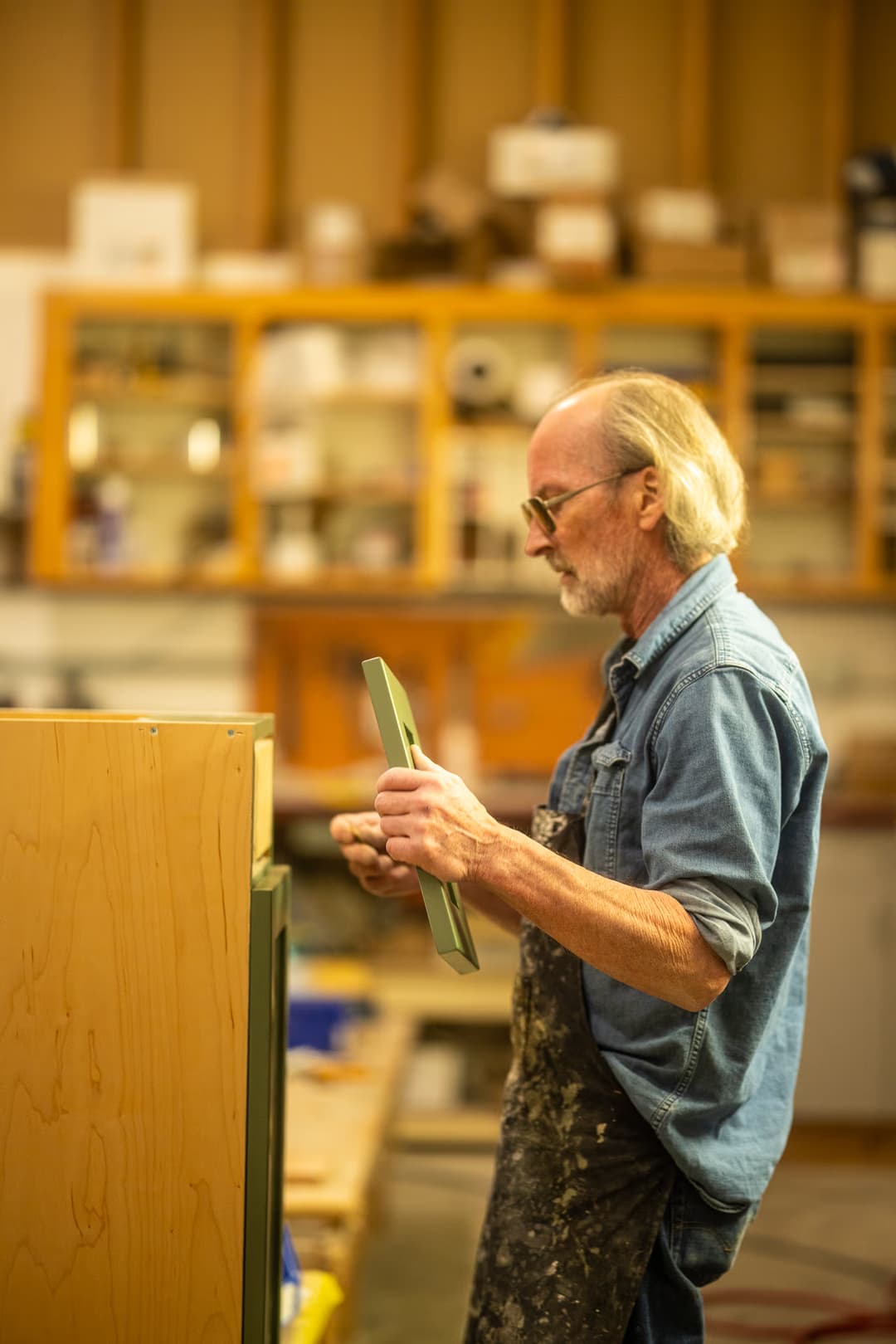 Man attaching a cabinet door