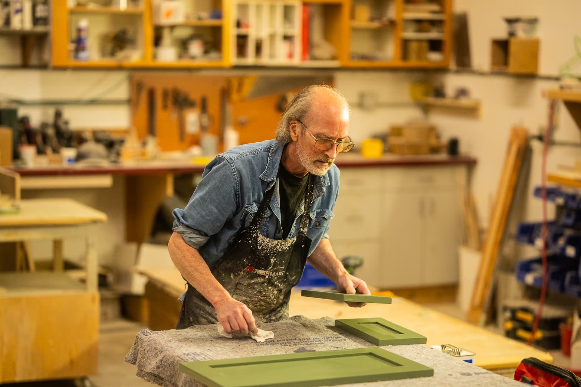 a man working on a cabinet door