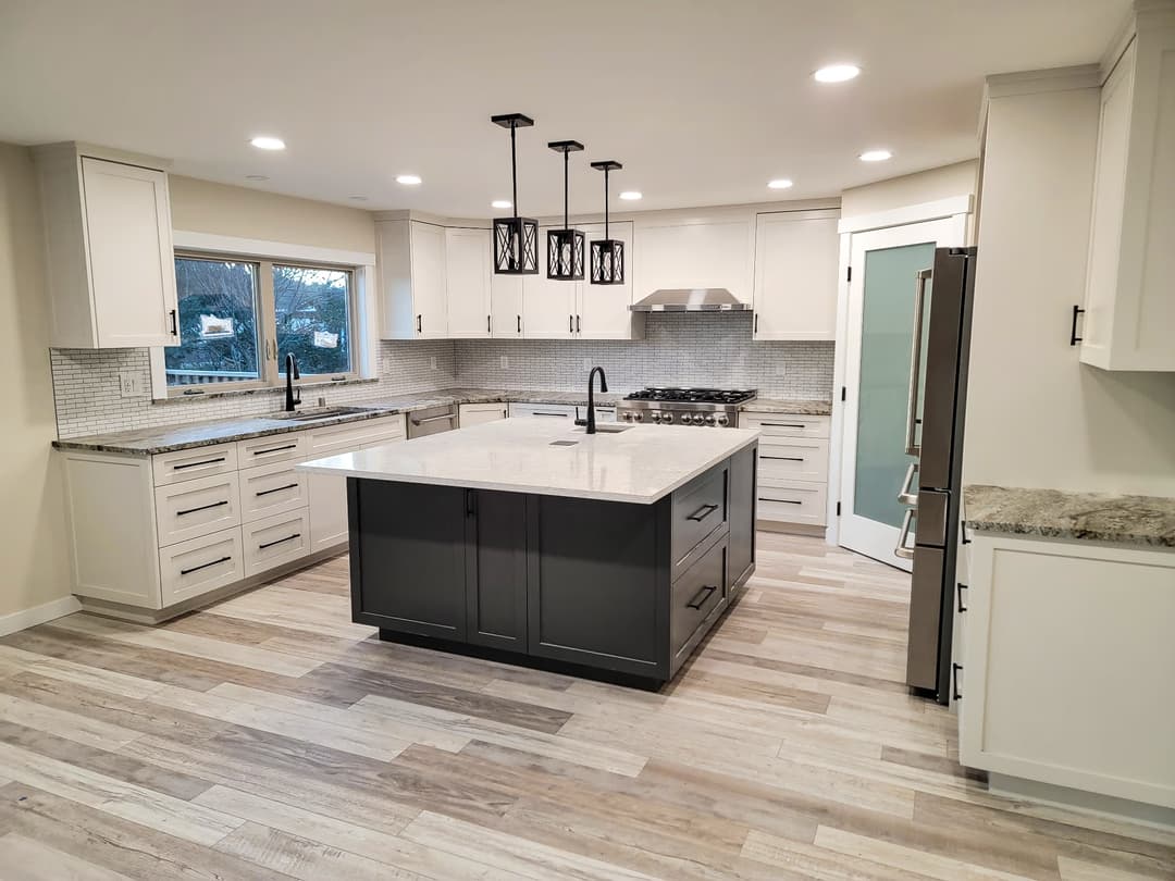 a finished kitchen remodel with a large island and custom cabinetry